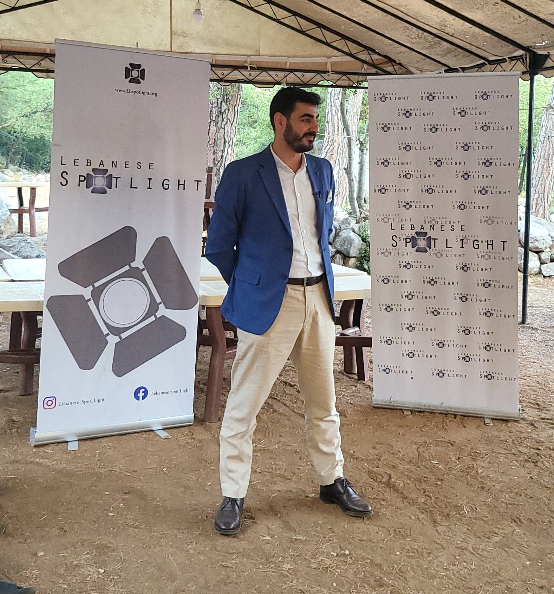 side shot of Anthony Abi Zeid giving speech on stage in front of Lebanese Youth